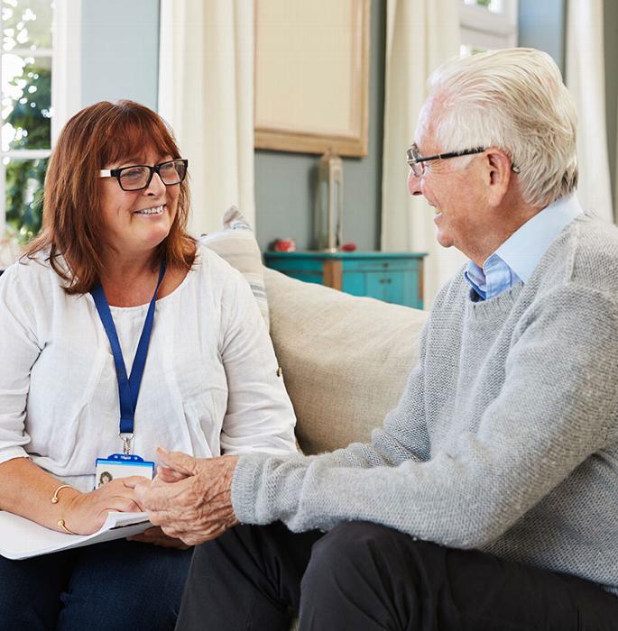 elderly man talking with care assessor
