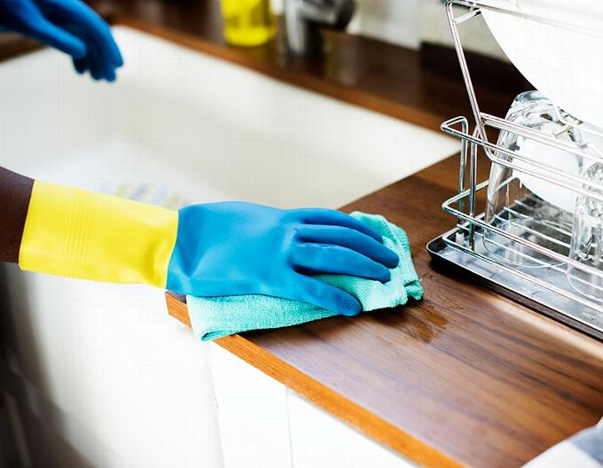 man's hand in rubber glove cleaning Kitchen side