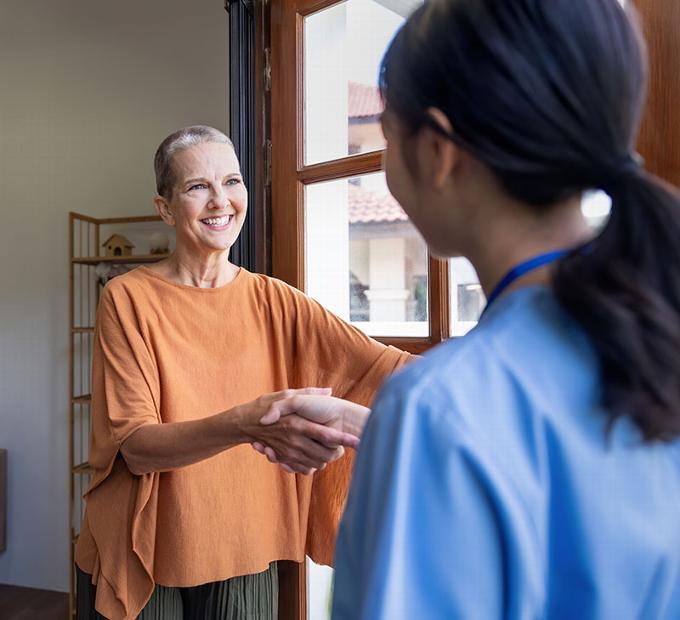 carer with lady at door